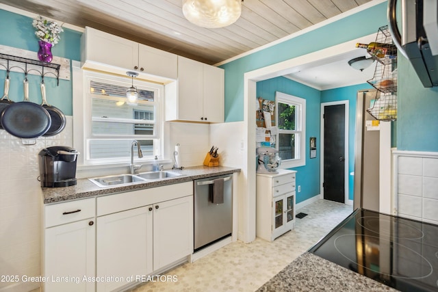 515 N Fairview Ave, Lansing, MI 48912 - kitchen featuring stainless steel dishwasher, ornamental molding, white cabinetry, light flooring, and stove