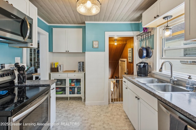 515 N Fairview Ave, Lansing, MI 48912 - kitchen featuring appliances with stainless steel finishes, white cabinetry, wooden ceiling, hanging light fixtures, and light flooring