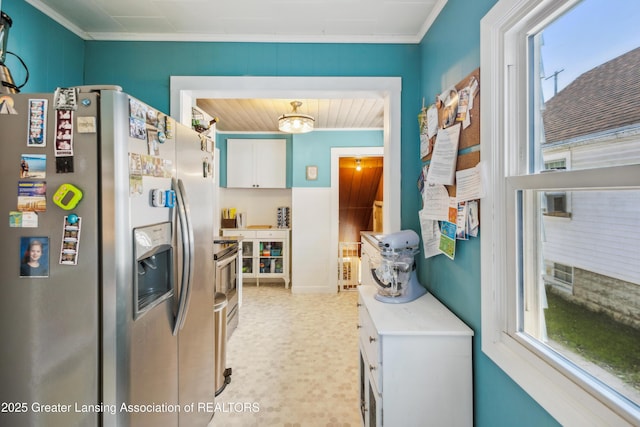 515 N Fairview Ave, Lansing, MI 48912 - kitchen with stainless steel appliances, white cabinets, crown molding, light countertops, and light flooring