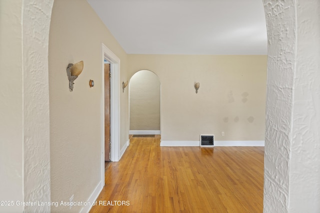 2335 Harding Ave, Lansing, MI 48910 - unfurnished room with arched walkways and light wood finished floors