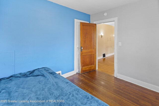 2335 Harding Ave, Lansing, MI 48910 - bedroom with dark wood-style flooring and baseboards