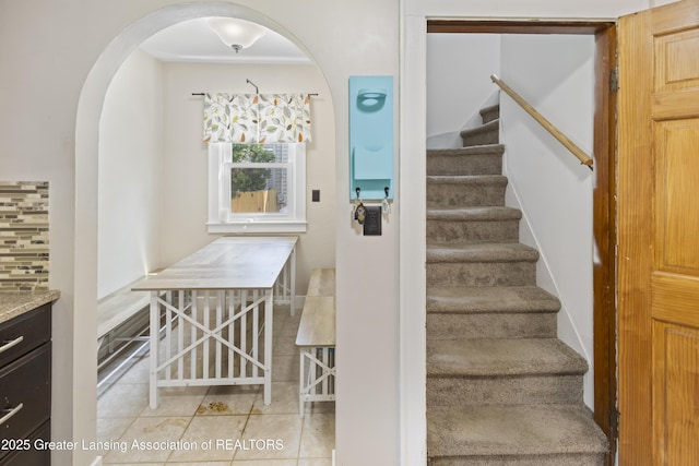 2335 Harding Ave, Lansing, MI 48910 - staircase featuring arched walkways and tile patterned flooring