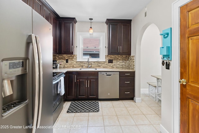 2335 Harding Ave, Lansing, MI 48910 - kitchen with appliances with stainless steel finishes, light countertops, and tasteful backsplash