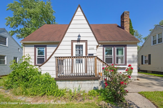 2335 Harding Ave, Lansing, MI 48910 - view of front facade with a chimney and a shingled roof