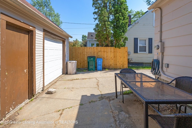 2335 Harding Ave, Lansing, MI 48910 - view of patio / terrace with a garage and driveway