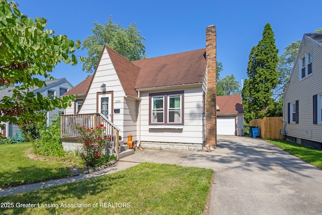 2335 Harding Ave, Lansing, MI 48910 - view of front facade with a chimney and a detached garage