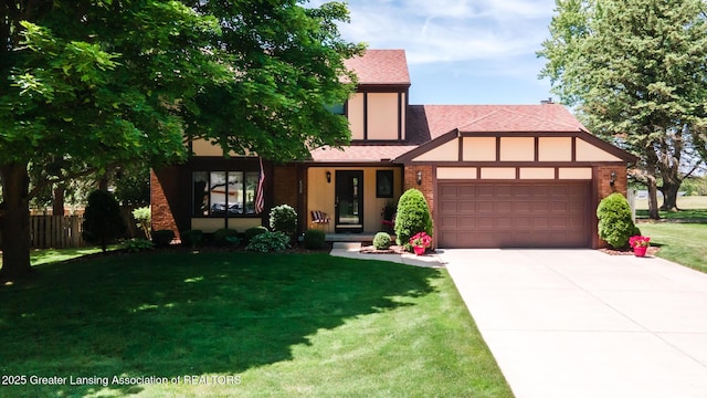 5939 Highgate Ave, East Lansing, MI 48823 - tudor-style house with a garage, brick siding, a shingled roof, and driveway