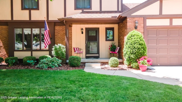 5939 Highgate Ave, East Lansing, MI 48823 - entrance to property with brick siding, a garage, a porch, and a lawn