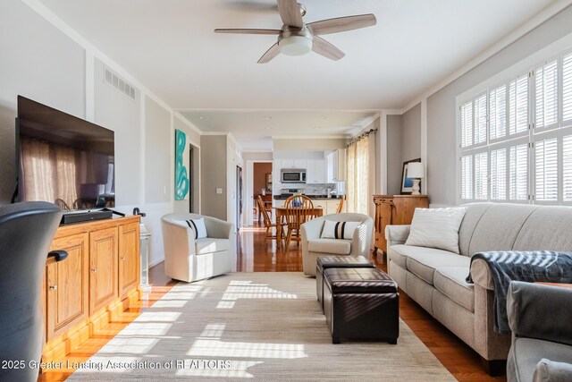 5939 Highgate Ave, East Lansing, MI 48823 - living room featuring plenty of natural light, light wood-type flooring, and a ceiling fan