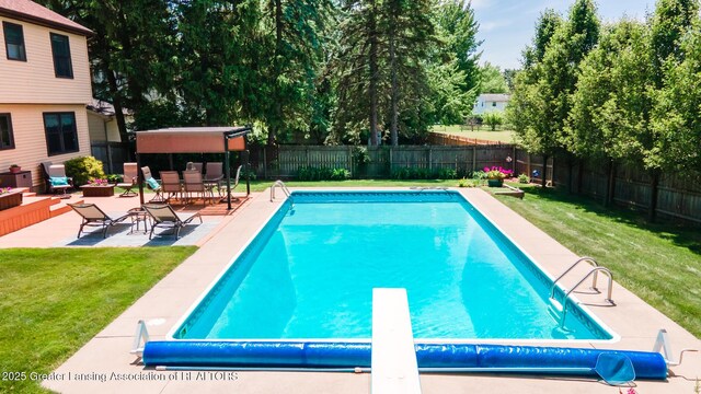 5939 Highgate Ave, East Lansing, MI 48823 - view of swimming pool featuring a fenced backyard, a patio area, and a diving board
