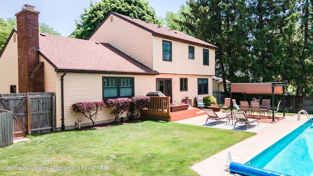 5939 Highgate Ave, East Lansing, MI 48823 - rear view of house with a fenced backyard, a deck, a chimney, roof with shingles, and a gate