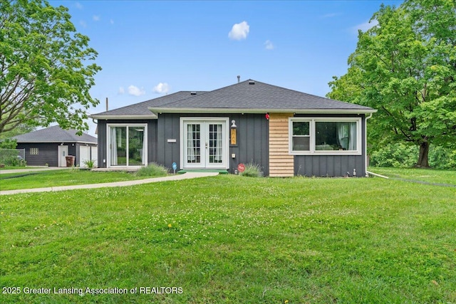 3707 W Michigan Ave, Lansing, MI 48917 - rear view of house with french doors, board and batten siding, and a yard