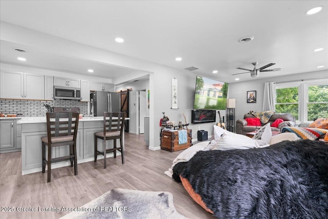 3707 W Michigan Ave, Lansing, MI 48917 - bedroom with freestanding refrigerator, recessed lighting, and light wood-type flooring