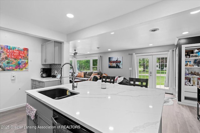 3707 W Michigan Ave, Lansing, MI 48917 - kitchen featuring gray cabinetry, light wood-type flooring, french doors, plenty of natural light, and recessed lighting