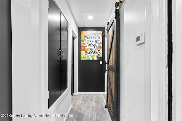 3707 W Michigan Ave, Lansing, MI 48917 - corridor with a barn door, light wood-style floors, and recessed lighting