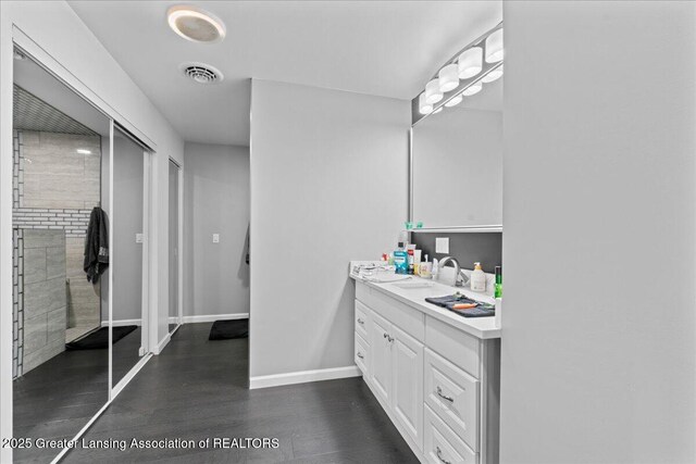 3707 W Michigan Ave, Lansing, MI 48917 - bathroom with vanity and wood finished floors