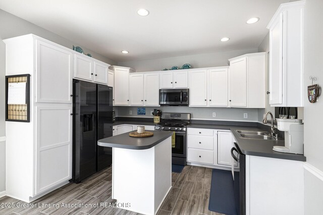 491 Anhinga Dr, East Lansing, MI 48823 - kitchen with stainless steel appliances, dark countertops, white cabinets, wood tiled floors, and recessed lighting
