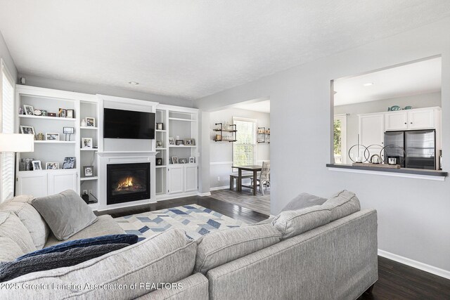 491 Anhinga Dr, East Lansing, MI 48823 - living room with dark wood finished floors and a glass covered fireplace