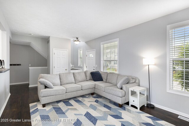 491 Anhinga Dr, East Lansing, MI 48823 - living area with healthy amount of natural light, wood finished floors, and stairs