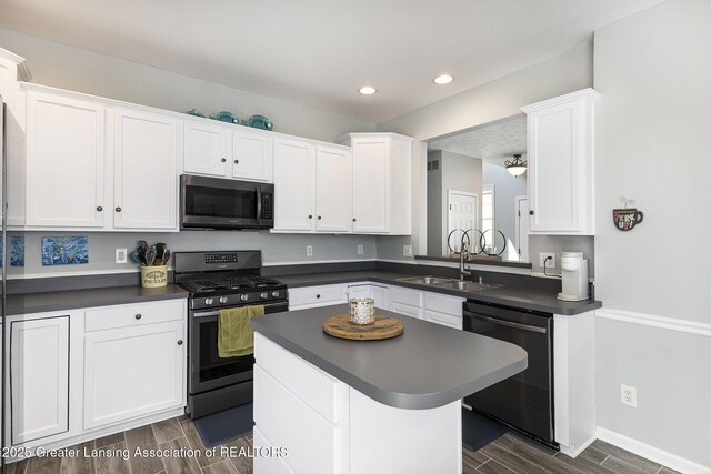491 Anhinga Dr, East Lansing, MI 48823 - kitchen featuring dishwasher, stainless steel range with gas stovetop, dark countertops, white cabinetry, and recessed lighting