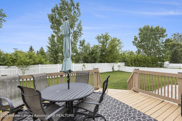 491 Anhinga Dr, East Lansing, MI 48823 - wooden deck with outdoor dining area and a fenced backyard