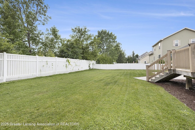 491 Anhinga Dr, East Lansing, MI 48823 - fenced backyard with stairs and a wooden deck