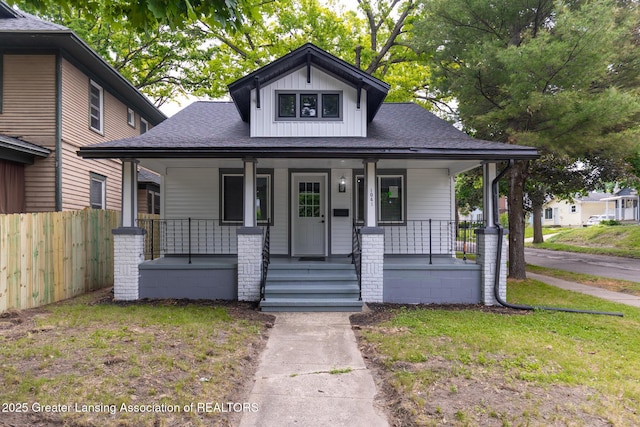 1041 Parker St, Lansing, MI 48912 - view of front of house featuring covered porch, a shingled roof, and board and batten siding
