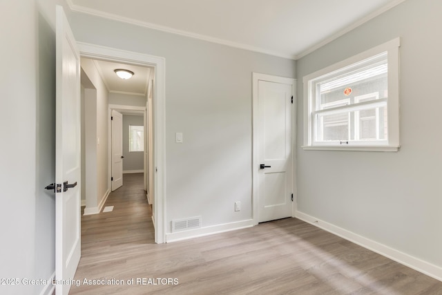1041 Parker St, Lansing, MI 48912 - unfurnished bedroom featuring crown molding and light wood finished floors