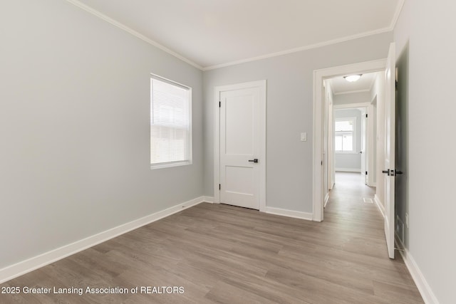 1041 Parker St, Lansing, MI 48912 - unfurnished bedroom featuring crown molding and light wood finished floors