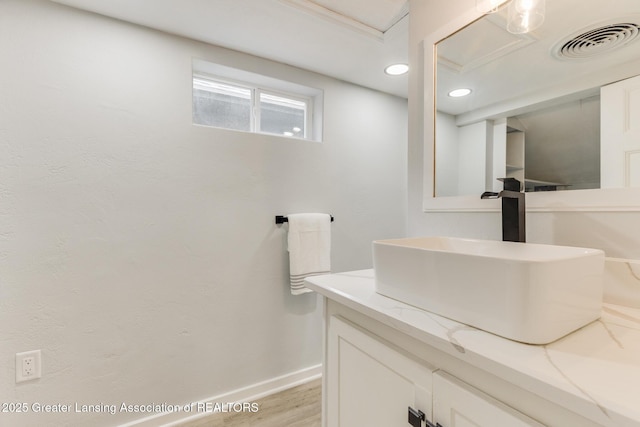 1041 Parker St, Lansing, MI 48912 - bathroom featuring vanity, wood finished floors, and recessed lighting