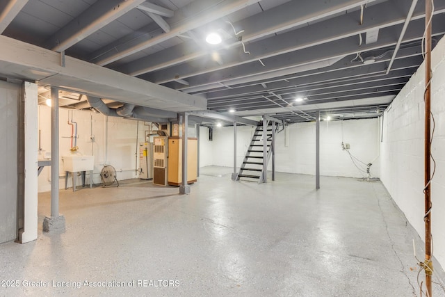1041 Parker St, Lansing, MI 48912 - unfinished below grade area with water heater, stairs, and heating unit