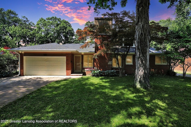 1603 Roseland Ave, East Lansing, MI 48823 - view of front of house featuring brick siding, driveway, an attached garage, and a front lawn