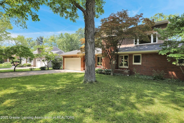 1603 Roseland Ave, East Lansing, MI 48823 - view of front of property featuring concrete driveway, a garage, a front lawn, and brick siding