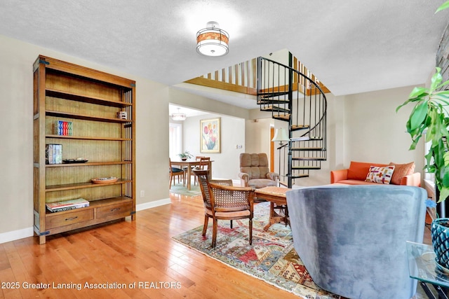 1603 Roseland Ave, East Lansing, MI 48823 - living room featuring stairs, light wood-type flooring, and a textured ceiling