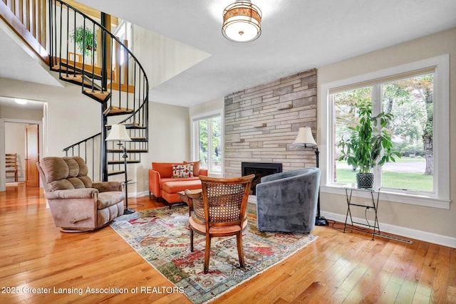 1603 Roseland Ave, East Lansing, MI 48823 - living room featuring stairs, wood-type flooring, and a fireplace