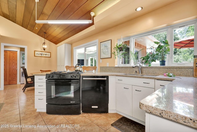 1603 Roseland Ave, East Lansing, MI 48823 - kitchen with black appliances, lofted ceiling, light tile patterned flooring, white cabinets, and a peninsula