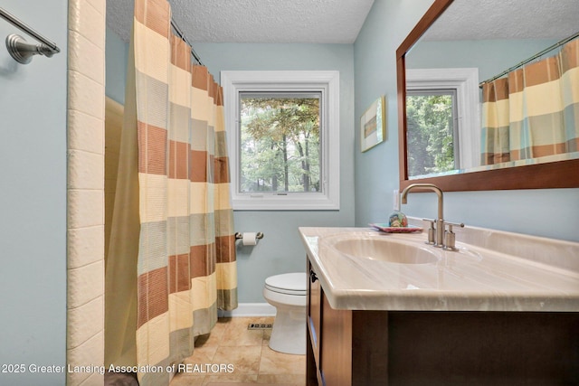 1603 Roseland Ave, East Lansing, MI 48823 - full bathroom with a textured ceiling, vanity, tile patterned floors, and a shower with curtain