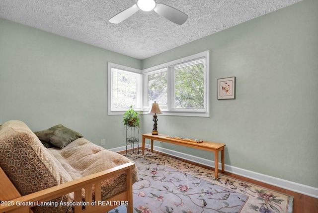 1603 Roseland Ave, East Lansing, MI 48823 - living area featuring a textured ceiling, ceiling fan, and wood finished floors