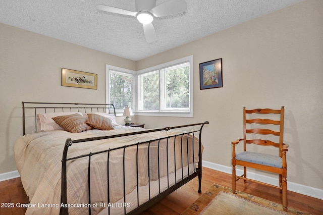 1603 Roseland Ave, East Lansing, MI 48823 - bedroom featuring a textured ceiling, wood finished floors, and a ceiling fan