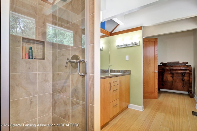1603 Roseland Ave, East Lansing, MI 48823 - bathroom featuring wood finished floors, vanity, and a stall shower