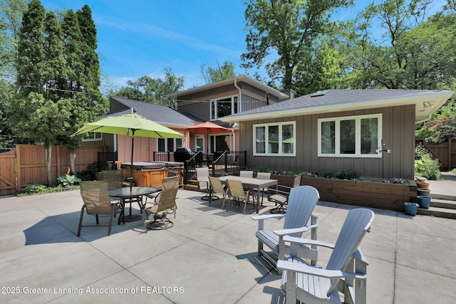 1603 Roseland Ave, East Lansing, MI 48823 - view of patio with outdoor dining area and a hot tub