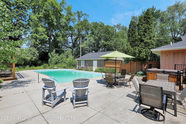 1603 Roseland Ave, East Lansing, MI 48823 - view of pool with a hot tub, outdoor dining area, a patio area, and view of scattered trees