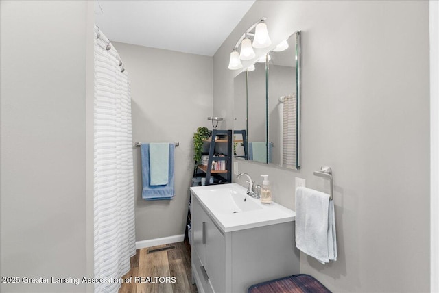 2914 W Holmes Rd, Lansing, MI 48911 - full bath featuring vanity and wood finished floors