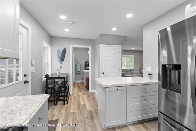 2914 W Holmes Rd, Lansing, MI 48911 - kitchen with stainless steel fridge, light wood-style flooring, recessed lighting, light stone counters, and gray cabinetry