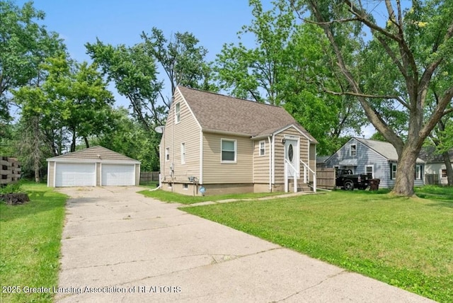 2914 W Holmes Rd, Lansing, MI 48911 - view of front of property featuring a detached garage, entry steps, an outbuilding, and a front yard