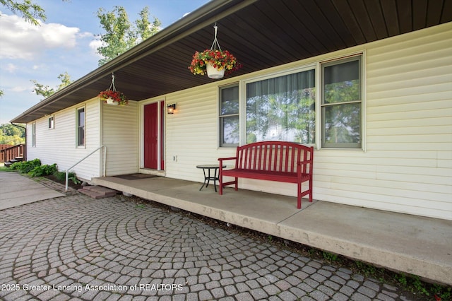 1234 Lamb Rd, Mason, MI 48854 - entrance to property with a porch