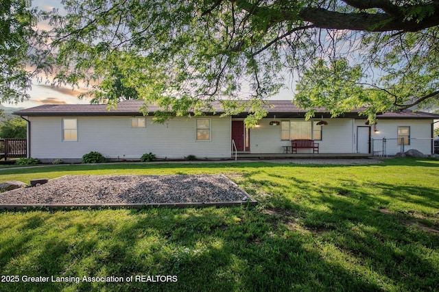 1234 Lamb Rd, Mason, MI 48854 - rear view of house with a lawn and a porch