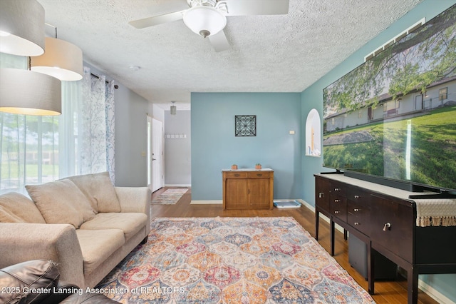 1234 Lamb Rd, Mason, MI 48854 - living area with wood finished floors, ceiling fan, and a textured ceiling