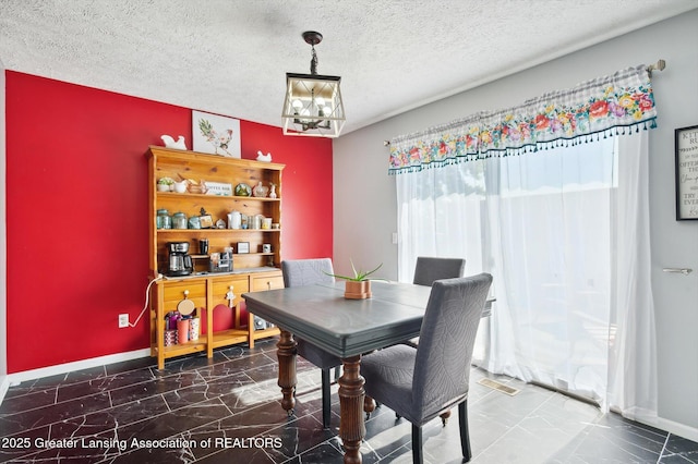 1234 Lamb Rd, Mason, MI 48854 - dining space featuring a chandelier, marble finish flooring, and a textured ceiling