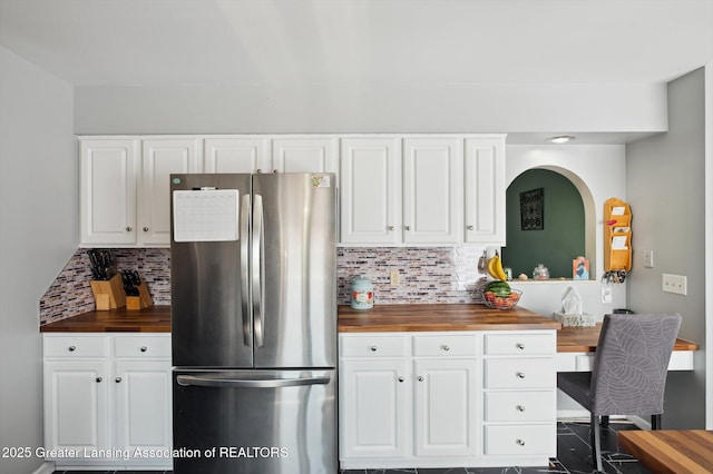 1234 Lamb Rd, Mason, MI 48854 - kitchen featuring freestanding refrigerator, butcher block countertops, decorative backsplash, and white cabinetry